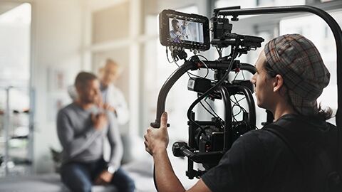 Camera man filming a scene in a doctor's office