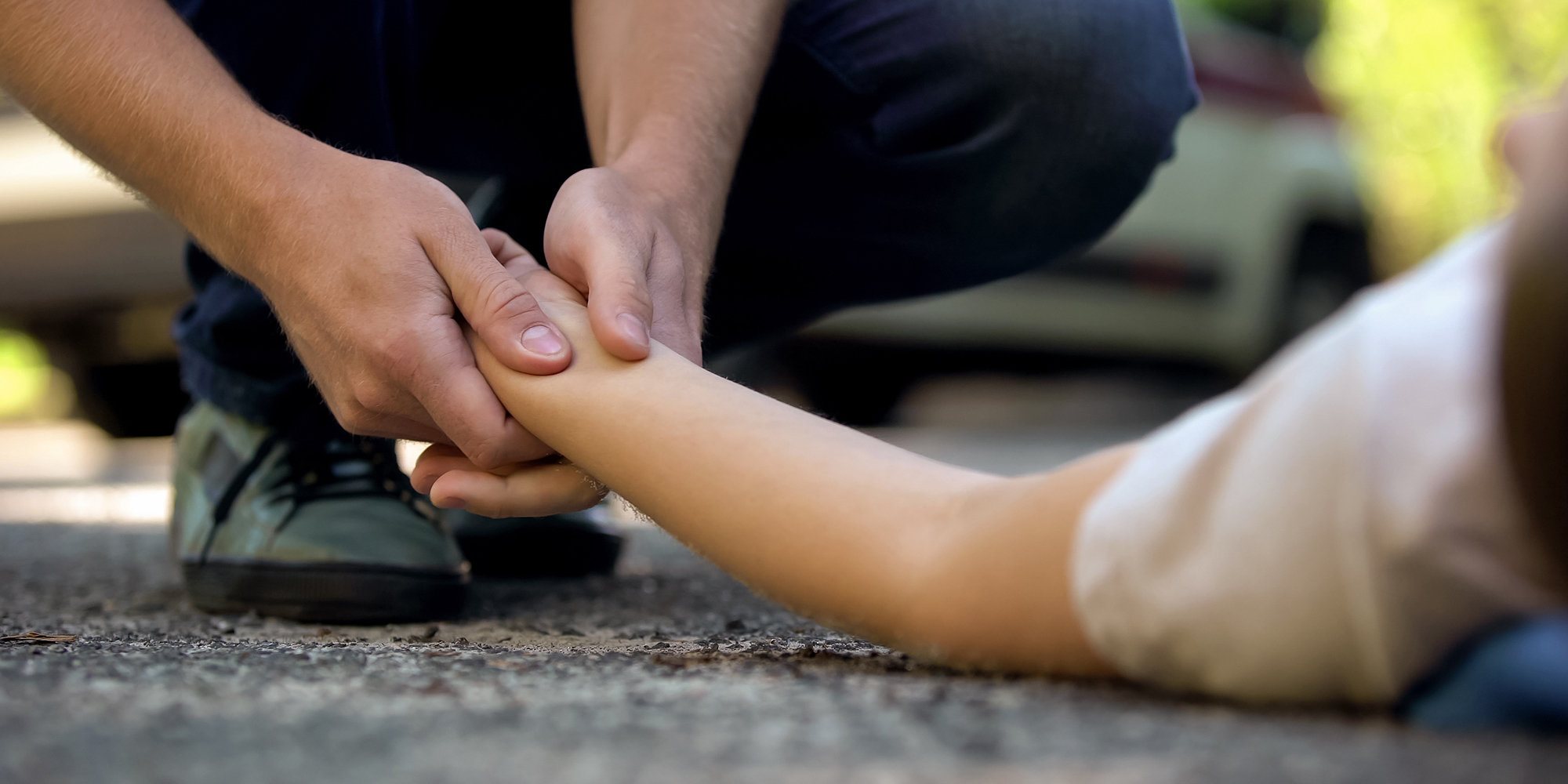Someone holding the hand of an injured pedestrian