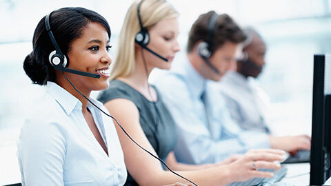 Workers in a contact center responding to incoming phone calls.