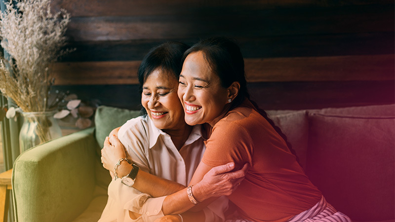 Two women hugging and supporting each other in a time of crisis