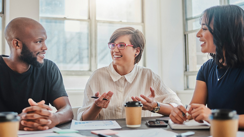 Diverse group of co-workers sitting around a conference table